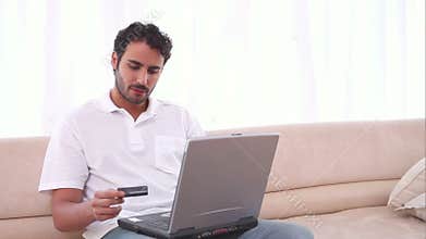Man using his laptop and a credit card