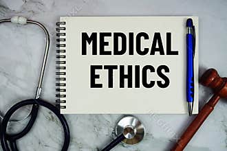 Medical Ethics text written on notepad with stethoscope and gavel on marble background