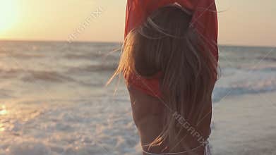 Beautiful girl with long blond hair walking on the