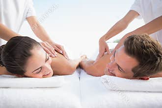 Peaceful couple enjoying couples massage poolside