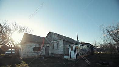 Panorama of a white brick country house with a car parked nearby. Lifestyle russian village
