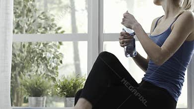 Woman having a break after working out at home