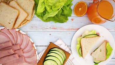 Making sandwich on the table full with food for breakfast and eating - stop motion