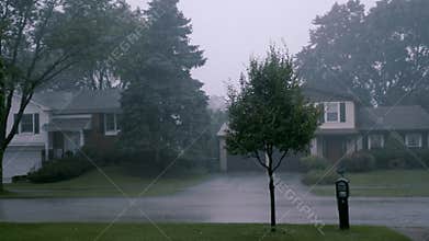 Thunderstorm in the village, heavy rain, trees in the wind. Hurricane, severe weather conditions, Suburbs,