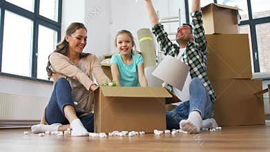 Happy family playing with foam peanuts at new home