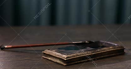 Writing calligraphy. Dip the water level with a brush and ink. The writing tools of Asians. Ancient Asian writing. Asian writing s