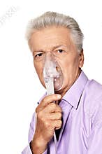 Portrait of sick senior man with inhaler isolated