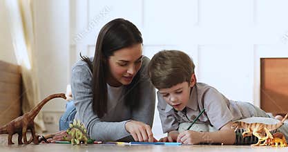 Caring mother involved in creative activity with little son.