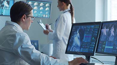 Medical doctors working in hospital office making computer research. Medicine, healthcare and technology concept.