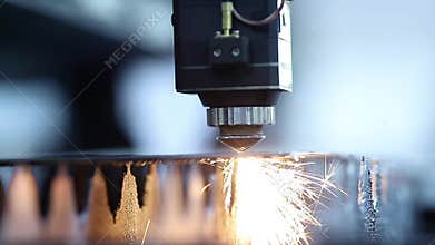 Blue color Laser CNC cut of metal with light spark, technology modern industrial