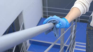 Disinfection of the railing on the staircase in a public space during the quarantine period