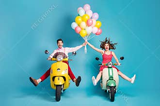 Full body photo of crazy two people lady guy drive retro moped travelers spread legs raise arms many air balloons
