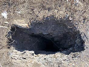 A pit, a non-man-made hole in the ground