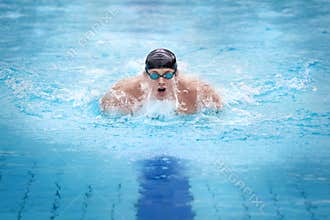 Man swimmer in cap taking breath
