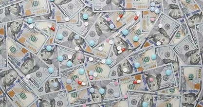 Drugs on money background, medical insurance