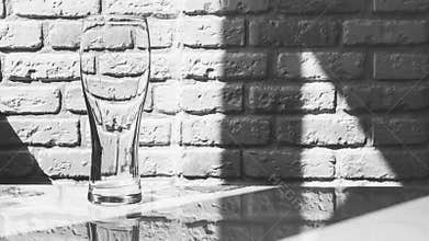 Empty beer glass white wall background