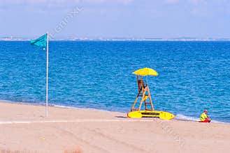 Beautiful white-sand beach, turquoise sea with no people, only lifeguard