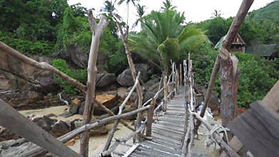 Walk on old wooden bridge over the rocks