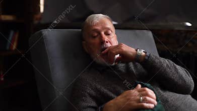 Bearded mature man lying on couch and talking about his problems with professional psychotherapist.