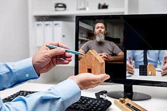 Virtual meeting with businessmen, man showing house with solar panel