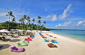 Ilig Iligan Beach in the Western Visayas, Philippines with large colourful bean bags with few tourists during the covid19 pandemic