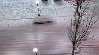 Aerial view of car driving on cold blizzard snow winter night