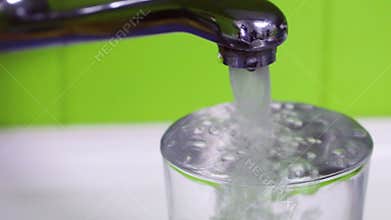 Glass of water filling to overflow