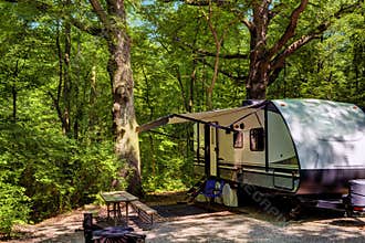 Travel trailer camping in the woods at starved rock state park
