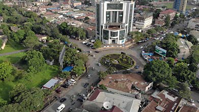 Aerial Close Flyby view of the city of Arusha, Tanzania Mountains and Volcano on Background.