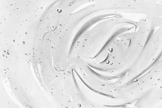 Face serum or gel texture. Clear skincare cream with bubbles background