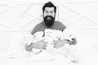 Toys for adult. Relax in bedroom. Back into childhood. Happy birthday. Man with beard happy face hold gift toys. Toys