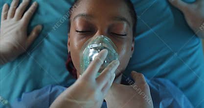 Paramedics checking pulse and putting oxygen inhalation mask on girl face. Close up of afro american woman lying on