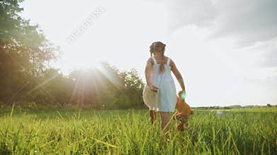 Little kid girl walk with a teddy bear toy in the park in nature. childhood dream concept. smiling kid child walk with
