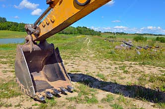 Agrimotor on green field and blue sky