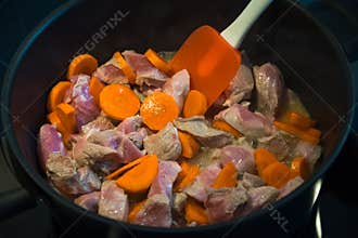 Cooking meat stew with carrots