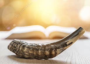 Yom Kippur and Rosh Hashanah Hashana jewish New Year holiday concept with Ram shofar horn with religious holy prayer book