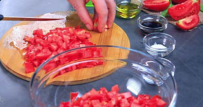 Woman hands cutting fresh toamtoes for prepare bruschettas or salad