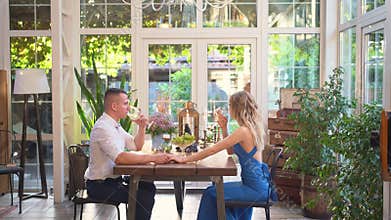 Romantic dinner for couple. lovers drink wine from glasses.