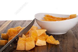 Cut up cantaloupe and knife on cutting board