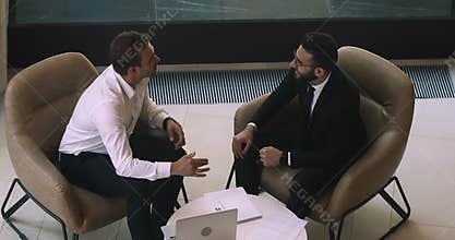 Happy diverse business partners talking handshaking at office meeting