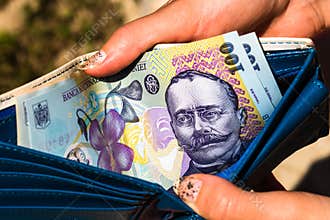 Hands holding and showing wallet with romanian money LEI