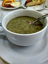 Soup of mashed potatoes with spinach in a white porcelain bowl on the table.  The concept of proper nutrition, vegeta