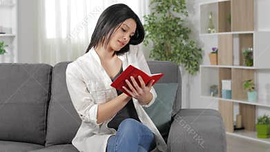 Woman talking on phone and writing in agenda