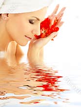 Lady with red petals in water