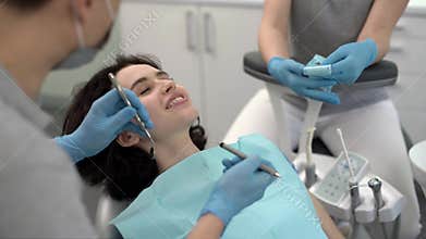Pretty woman`s teeth treatment in dental clinic