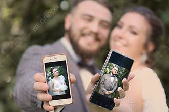 Wedding couple bride with mobiles phone close up photo