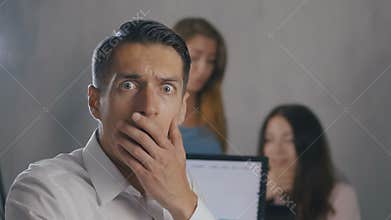 Businessman shocked and surprised while reading a message in the smartphone at office background. Man scared when he