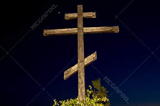 Huge wooden Orthodox eight-pointed cross against the sky after sunset on Mount Athos