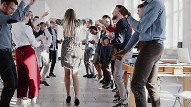 Happy fun beautiful young blonde boss business woman dancing with multiethnic team at office party slow motion RED EPIC.