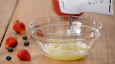 Beating egg whites to stiff peaks. Making pastry dough.